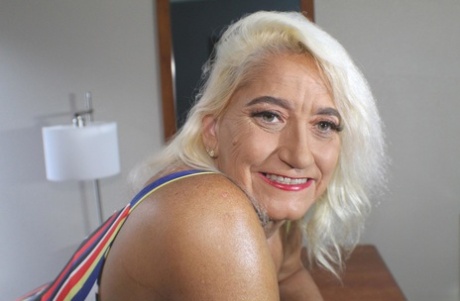 Blonde granny Amber Conners hikes her dress up to show her massive ass