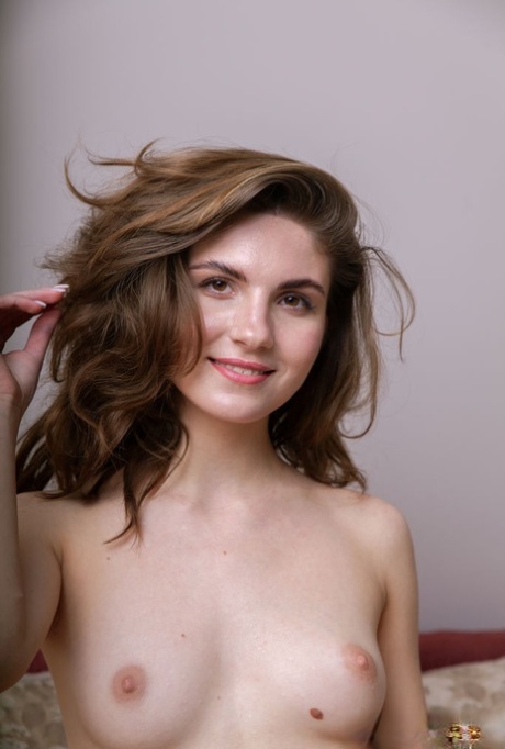 Barely legal girl Kassandra highlights her hairless pussy while getting naked